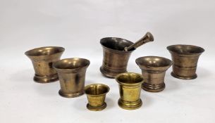 19th century bell metal pestle and mortar having a ringed body and rounded base, mortar 13cm high