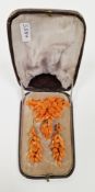 Victorian coral brooch and earring suite, carved in the form of flower and foliage bouquets, the