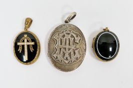 Three Victorian oval mourning lockets including two with black enamel panels on yellow metal