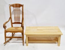French hardwood spindleback rocking chair with scrolling arms and rush seat, signed to base, 109cm