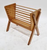 Mid-century teak magazine rack with horizontal turned spindle sides, on a X-frame supports, 42cm