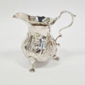 George III silver cream jug, London 1973, makers mark ET(?), of baluster form with wavy rim,