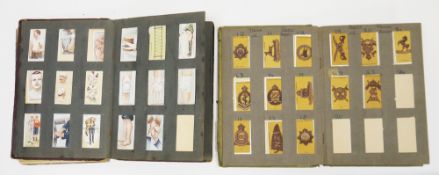 Two early 20th century cigarette card albums containing various part sets of loose cigarette