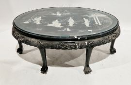 Chinese ebonised hardwood oval coffee table, the top with applied and painted mother-of-pearl star