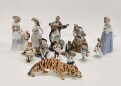 Four Chinese mudman figures including one playing a mandolin and another seated fishing, tallest