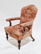 19th century open armchair, having shaped button back, upholstered in a pink floral fabric, on a