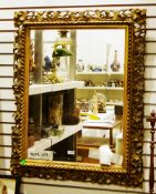 20th century rectangular mirror, the gilt frame with a gadrooned edge and pierced foliate scroll