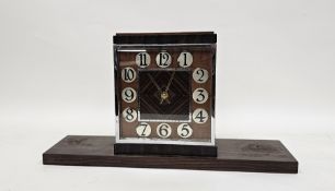 Art Deco mantel clock of square form in walnut and rosewood case with applied chrome numerals, the
