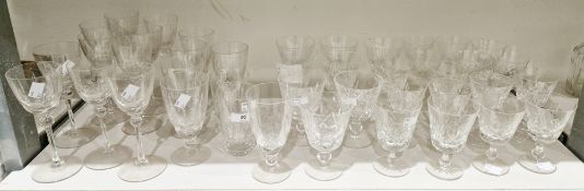 Two cut glass part table services, the first cut with fans and diamonds with baluster stems, the