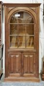 Oak display cabinet cupboard in the 17th century manner, the single arched glazed door opening to