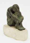 Bronze limited edition sculpture of a figure with head resting on knees, signed ' Florens Toys '  ?,