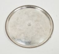 George V silver card tray, of circular form, engraved with a crest of a stag's head within laurel