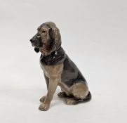 Royal Copenhagen porcelain model of a seated bloodhound, modelled by Lauritz Jensen, its fur