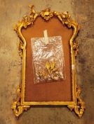 20th century gilt wooden frame in the rococo manner, carved with foliate scrolls and surmounted by a