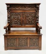 Victorian oak hall bench, the panelled back carved with side profile portraits, cherubs, birds, lion