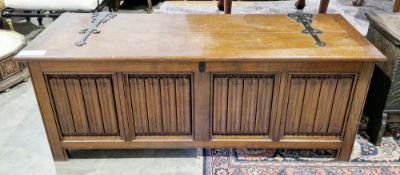 Large oak coffer in the 17th century manner, the lid with iron strapwork hinges opening to a pine