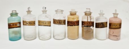 Eight late 19th/early 20th century labelled glass apothecary bottles and stoppers, each of
