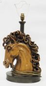 Mid-century wooden effect resin table lamp in the form of a horse's head with curling mane, on an