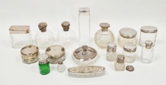 Collection of 17 silver-topped glass dressing jars and perfume bottles, mainly early 20th century