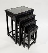 Mid-century South East Asian hardwood nest of four tables, the rectangular tops with relief