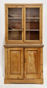 19th century pine glazed bookcase cupboard, the upper section with two glazed doors opening to two