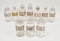 Ten early 20th century 'label under glass' apothecary bottles and assorted stoppers/droppers, each