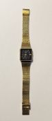 Gent's Rotary gilt metal bracelet watch, the square black dial with baton markers and date aperture,