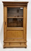 19th century continental pine part glazed cupboard, the moulded pediment over a single door with two