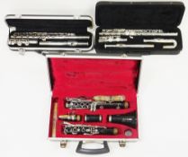 Three cased musical instruments including Odyssey OFL100 flute in hard case, Elkhart by Vincent Bach