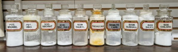 Ten small early 20th century 'label under glass' apothecary bottles and stoppers, each of