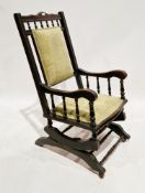 Late 19th/early 20th century American rocking chair with turned spindle supports, on castors,