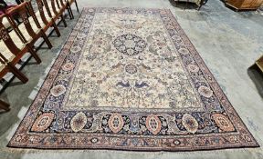 Large Persian wool cream ground carpet, the centre with tigers, birds, deer and other animals before