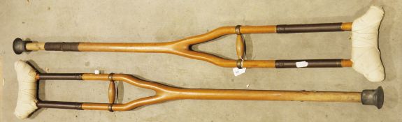 Pair of early 20th century wooden and brass mounted crutches, 136cm high