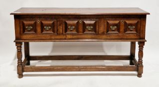 Jacobean revival oak dresser base, the rectangular top with thumbmould edge, over three moulded
