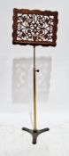 Victorian music stand, having a walnut fretwork carved sheet music holder on a brass cylindrical