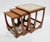 Mid-century G-Plan teak nest of three Astro tables, the largest with tiled top, G-Plan label to