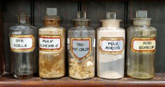 Five large early 20th century 'label under glass' apothecary bottles and stoppers, each of