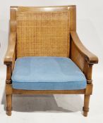 Hardwood and double cane bergere armchair in the manner of Wesley Barrell, having a blue weave