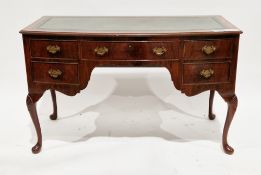 Early 20th century walnut bowfronted writing table/dressing table in the Queen Anne manner, the