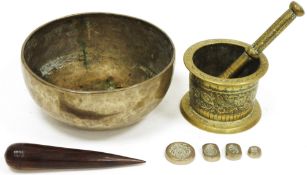 Tibetan brass singing bowl with hammered decoration, 24cm diameter, a lignum vitae turned baton,