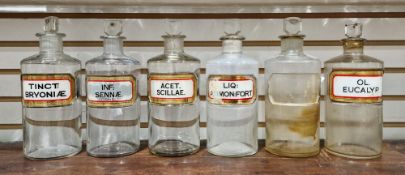 Six early 20th century 'label under glass' apothecary bottles and stoppers, each of cylindrical form