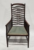 Edwardian mahogany and cross-banded elbow chair with ladderback and spindle arms, on square tapering