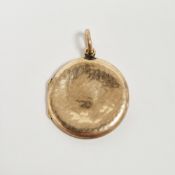 Early 20th century 9ct yellow gold photographic locket pendant of circular form with hammered