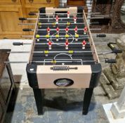 Pot Black children's 4ft football table, the plastic players in red and yellow kit, on telescopic