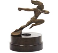Art Deco style brass car mascot modelled as a running Native American on a circular walnut plinth
