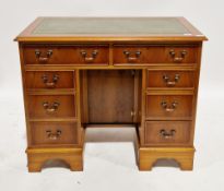 Modern yew wood twin-pedestal desk in the George III manner, with green leather inset writing