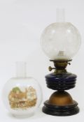 Late 19th / early 20th century oil lamp with globular etched clear glass shade, chimney, blue ribbed