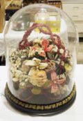 Large Victorian-style glass dome on a wooden base with three bun feet, holding a display of