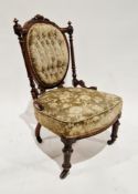 Victorian walnut framed low salon chair with buttoned upholstered back panel and stuffover seat,