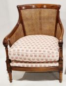Wesley Barrell contemporary double cane bergere and stained hardwood armchair with a cream